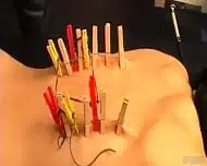 Blonde Woman Endures Painful Clothespins On Her Back