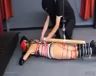Masked Dominant Binds A Woman In Red Rope